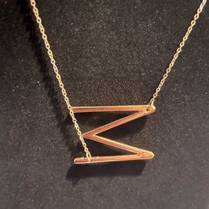 Letter M necklace in gold